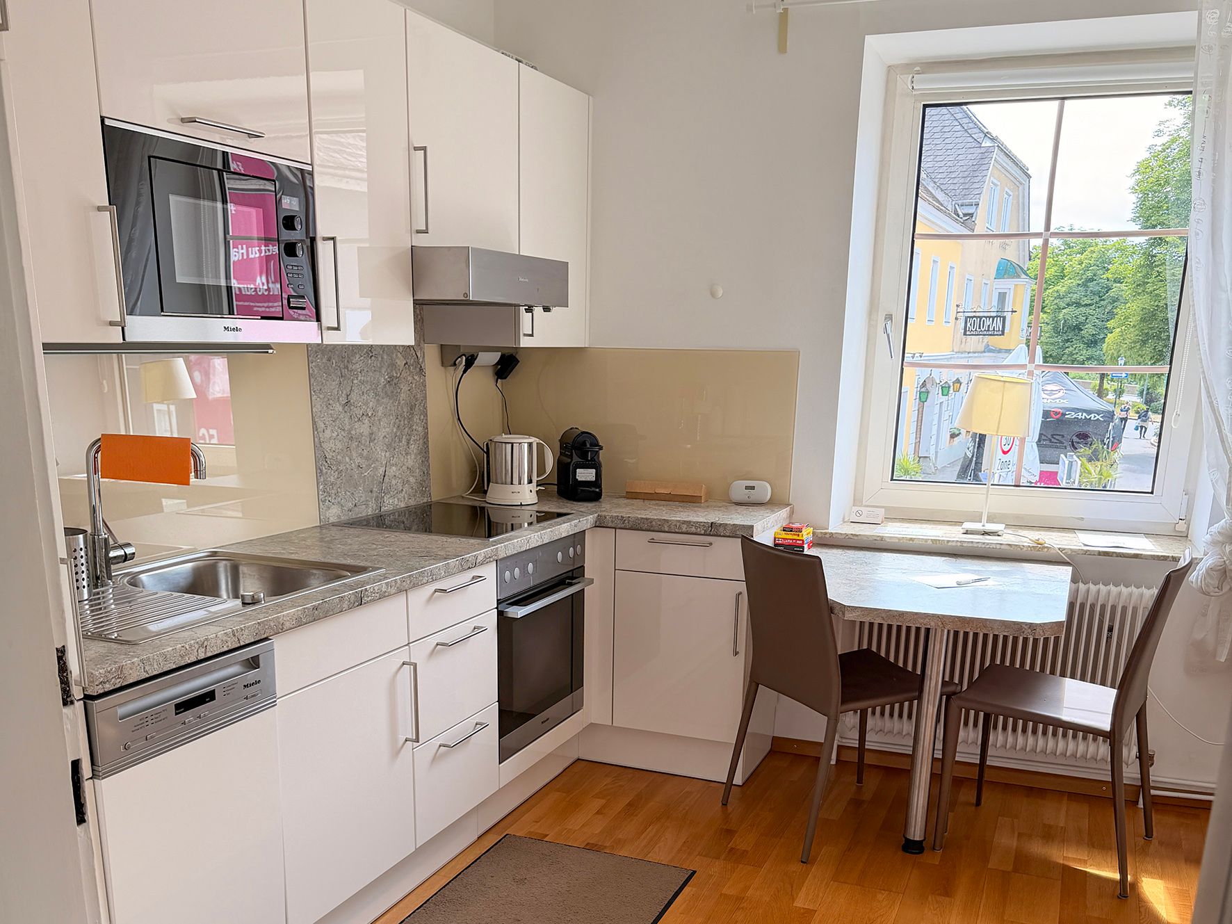 A kitchenette with a small seating area