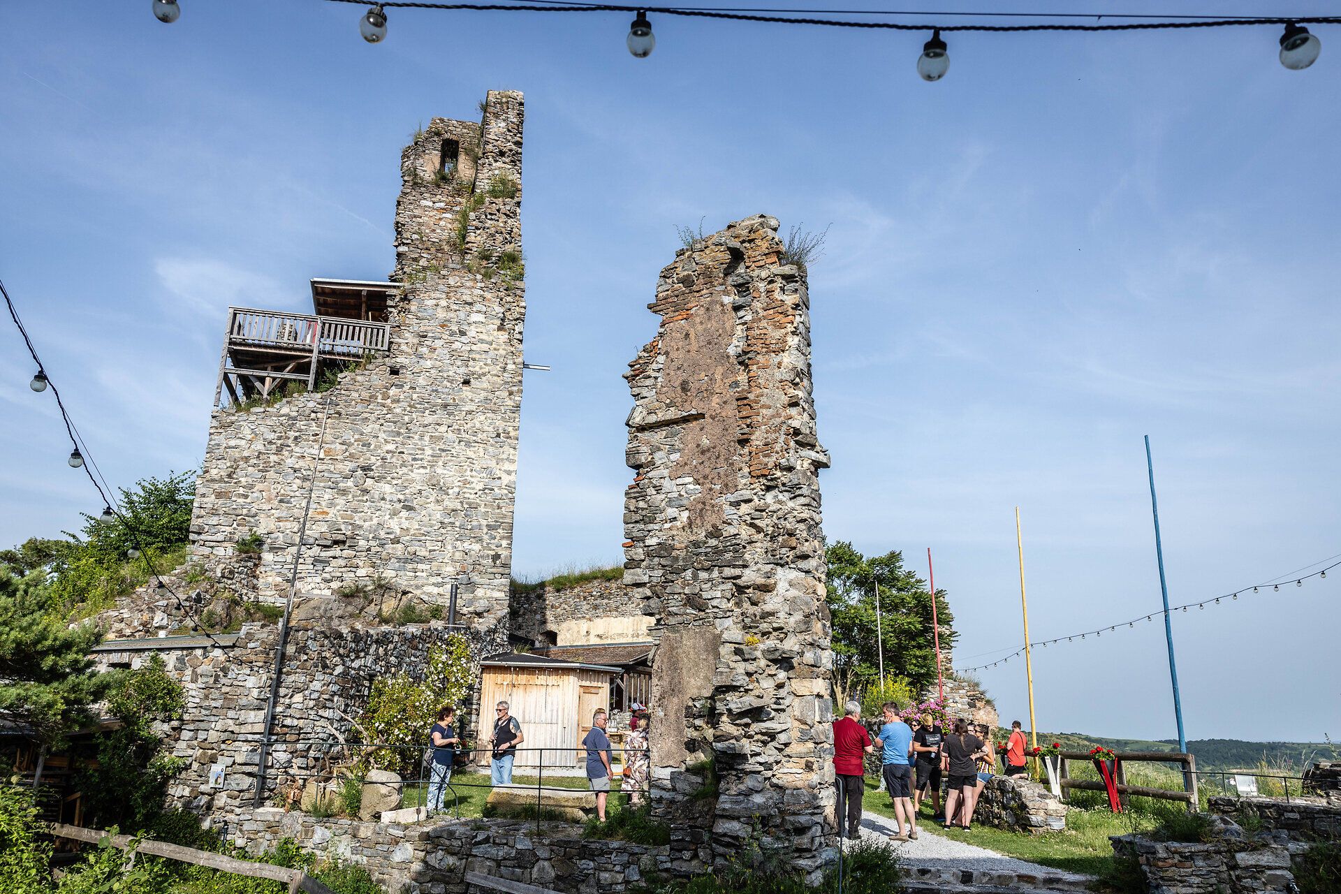 Bei der Ruine Senftenberg stehen Menschen und unterhalten sich.