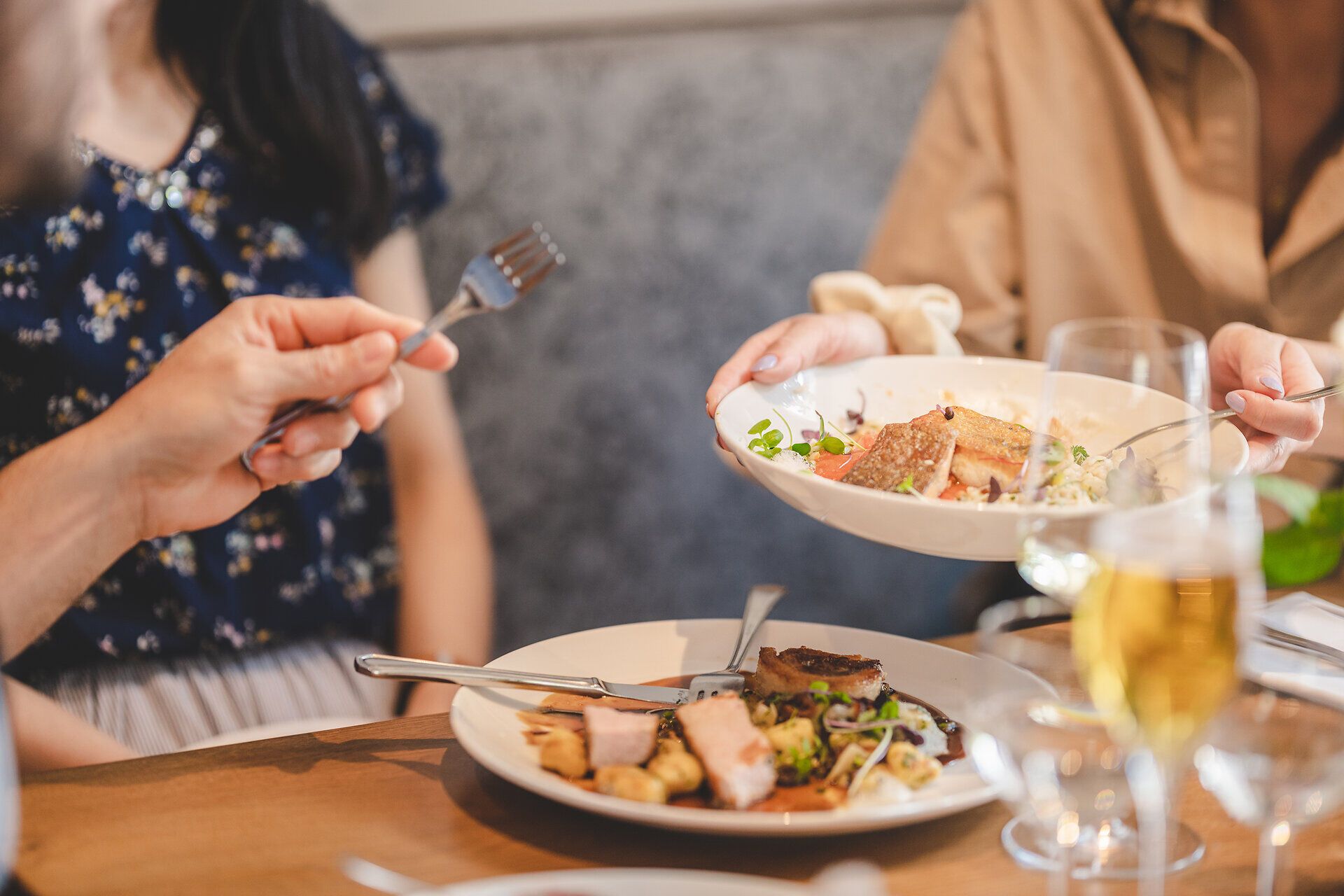 Zwei Teller mit jeweils unterschiedlichen Fischgerichten.