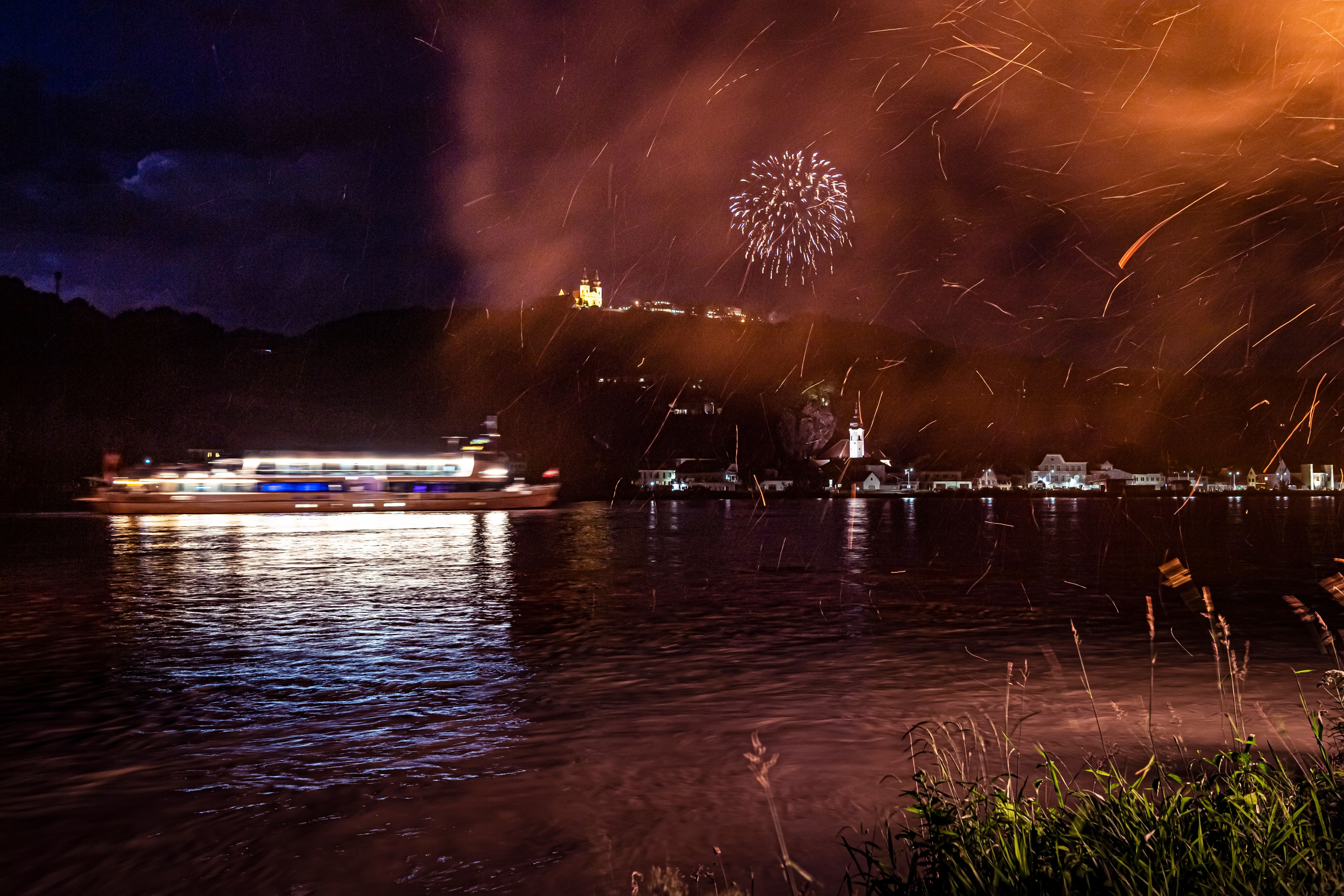 Ein Schiff fährt in der Dunkelheit auf der Donau und im Hintergrund ist Maria Taferl zu erkennen.