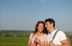 Paar lehnt sich eng aneinander, mit Ausblick auf die Weinberge.