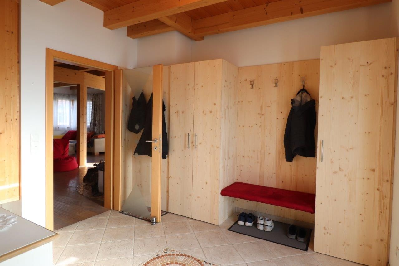 Eingangsbereich mit Fliesenboden und Vollholzgarderobe 