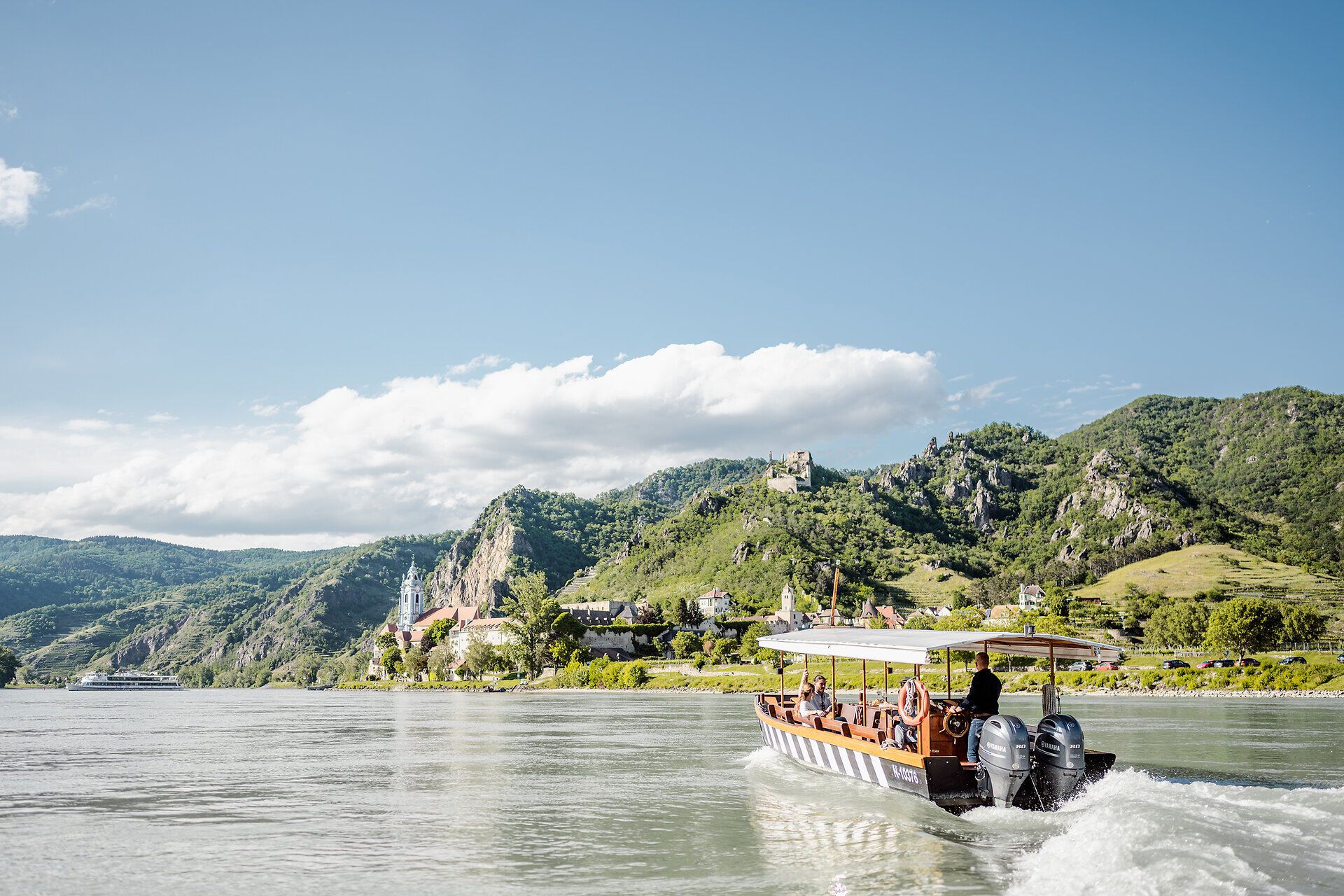 Die sanften Hügel der Wachau umarmen die Donau, während ein charmantes Boot gemächlich über das Wasser gleitet. Die üppige Landschaft, gespickt mit Weinbergen und historischen Burgen, lädt zu unvergesslichen Erlebnissen ein. Hier, wo Natur und Kultur harmonisch verschmelzen, wird jeder Moment zum Genuss.