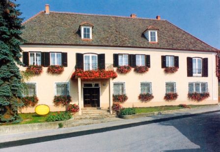 Traditionelles Gebäude mit Blumen an den Fenstern.