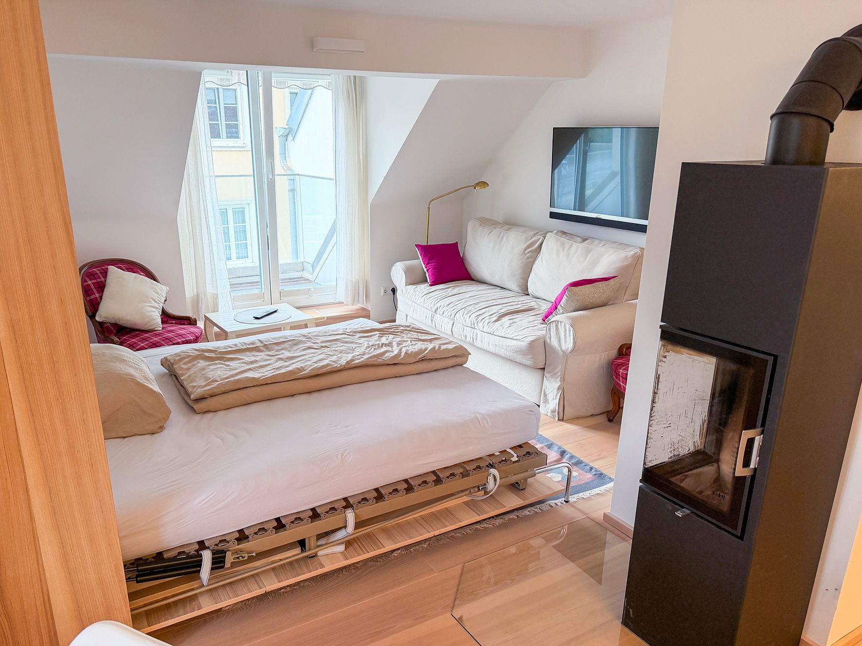 Bed with a couch in an attic apartment