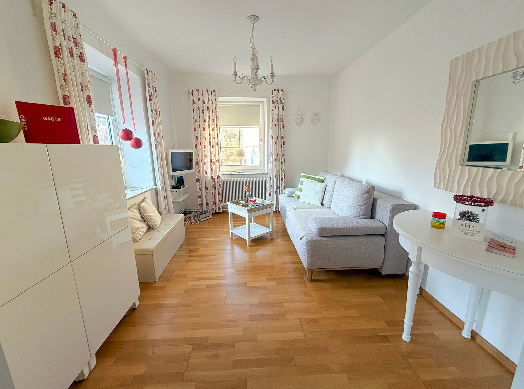 Living room with white furniture and hardwood floors