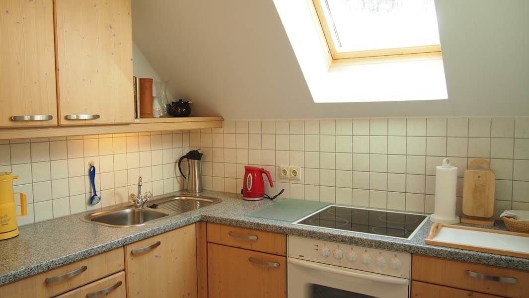 Kitchenette with sink, stove and skylight in the vacation home